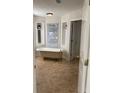 Elegant bathroom featuring a clawfoot tub, tiled floors, and built-in shelving for storage and decor at 1316 Milstead Ave, Conyers, GA 30012