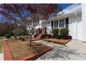 A lovely home with well-maintained landscaping, red brick accents and a walkway to the front door at 1316 Milstead Ave, Conyers, GA 30012