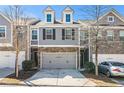 Charming townhome featuring a two-car garage and a welcoming exterior at 1530 Redbud Way, Tucker, GA 30083