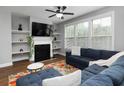 Cozy living room boasts a fireplace with built-in shelves and a comfortable sectional sofa at 2296 Whiteoak Se Dr, Smyrna, GA 30080