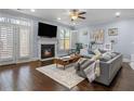 Cozy living room with a fireplace, large windows, hardwood floors, and stylish decor at 7630 Glisten Ave # 304, Atlanta, GA 30328