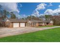 Expansive brick home with an oversized two-car garage, spacious driveway, and well-manicured lawn at 2716 Georgia 16, Carrollton, GA 30116