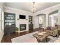 Cozy living room featuring a fireplace, custom built-ins, hardwood floors, and a neutral color palette at 2750 Vinings Orchard Se Cir, Atlanta, GA 30339