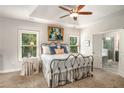 Relaxing bedroom with a tray ceiling, carpet floors, and an ensuite bathroom with a glass-enclosed shower at 2750 Vinings Orchard Se Cir, Atlanta, GA 30339
