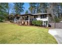 Beautifully landscaped yard with a charming porch and a winding driveway at 3480 Dunn Se St, Smyrna, GA 30080