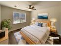 Staged bedroom featuring a ceiling fan, a large window, and minimalist decor at 70 Wall St, Hampton, GA 30228