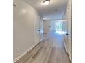 Inviting hallway with gray wood flooring leading to an open living space at 955 Magnolia Gardens Walk, Mcdonough, GA 30253