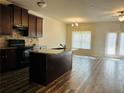 Open-concept kitchen with a central island, wood cabinets, and modern appliances at 1545 Iris Walk, Jonesboro, GA 30238