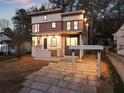 Charming two-story home with a modern design, well-lit exterior, and a stone driveway leading up to the house at 1045 Shepherds Ne Ln, Atlanta, GA 30324