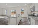 Open concept kitchen with granite countertops, a center island, and stainless steel appliances at 163 Sonoma Drive, Dallas, GA 30157