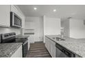 Bright kitchen featuring granite countertops, stainless steel appliances, and white cabinetry at 163 Sonoma Drive, Dallas, GA 30157