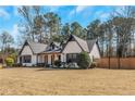 Stylish home showcasing a manicured lawn, and a privacy fence around the perimiter at 165 Sugarland Trl, Fayetteville, GA 30214