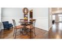 Elegant dining room features hardwood floors, wainscoting, and a modern pendant light at 2119 Dee Dee Muse Nw Ln, Atlanta, GA 30318