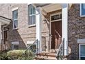 Close-up of the brick exterior featuring the front door and stoop of a townhome at 2119 Dee Dee Muse Nw Ln, Atlanta, GA 30318