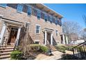 Charming brick townhome exterior with manicured landscaping, and inviting front stoop at 2119 Dee Dee Muse Nw Ln, Atlanta, GA 30318