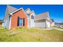 Exterior view of a two-story home showing the side of the house and the driveway at 104 Providence Dr, Carrollton, GA 30116