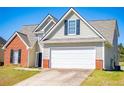 Two-story home with a two-car garage, brick accents, and neutral-toned siding at 104 Providence Dr, Carrollton, GA 30116