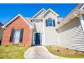 A two-story house features a brick facade, neutral siding, dark shutters, and a black front door at 104 Providence Dr, Carrollton, GA 30116