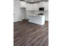 Bright kitchen with white cabinets, island, stainless steel appliances, and hard surface floors at 1063 Crest Mill Dr, Marietta, GA 30008