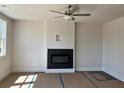 Elegant living room featuring a modern fireplace, ceiling fan, and ample natural light at 1063 Crest Mill Dr, Marietta, GA 30008