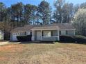 Charming one-story home with a well-manicured lawn, inviting porch, and attached garage at 325 Villa Rosa Way, Temple, GA 30179