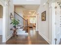 Elegant foyer with hardwood floors, staircase, and a view into the living room at 513 Beecham Dr, Smyrna, GA 30082