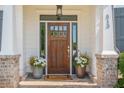 Close-up of the front door with brick accents and flower pots at 513 Beecham Dr, Smyrna, GA 30082