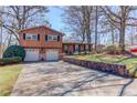 Charming split-level home featuring a well-maintained yard, stone accents and a two-car garage at 2685 Whippoorwill Cir, Duluth, GA 30097