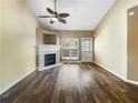 Inviting living room featuring a fireplace, ceiling fan, and stylish dark hardwood flooring at 3756 Brookwood Blvd, Rex, GA 30273