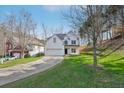 Lovely two-story home with a white exterior, set on a green lawn with a long driveway at 1811 Penny Nw Ln, Lawrenceville, GA 30043