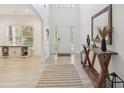 Bright foyer with light wood flooring, a console table, and an open view of the home at 1811 Penny Nw Ln, Lawrenceville, GA 30043