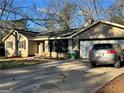Charming single-story home featuring an attached garage and driveway at 3511 Flint Ave, Ellenwood, GA 30294