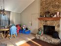 Cozy living room with vaulted ceilings and a stunning stone fireplace at 3511 Flint Ave, Ellenwood, GA 30294