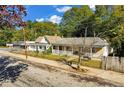 Inviting home showcasing a cozy front porch and a well-maintained yard, ideal for enjoying the outdoors at 1644 Lakewood Se Ave, Atlanta, GA 30315