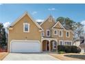 Charming two-story home with a well-manicured lawn and attached two-car garage at 385 Sweet Ivy Ln, Lawrenceville, GA 30043