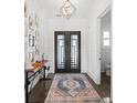 Elegant entryway with modern lighting, shiplap walls, and unique iron front doors at 441 Pumpkinvine Rd, Acworth, GA 30101
