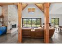 Living room with a brick fireplace, wood beams, and sliding glass doors to the back yard at 441 Pumpkinvine Rd, Acworth, GA 30101