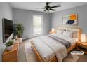 Serene bedroom featuring a ceiling fan, a comfortable bed, and natural light for a relaxing retreat at 4958 Meadow Ln, Marietta, GA 30068