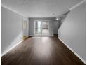 Bright living room with hardwood floors and large windows, ready for personalization and comfortable living at 4958 Meadow Ln, Marietta, GA 30068