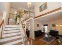 Bright foyer with hardwood floors, staircase with white banister, and an open view to the living room at 100 Cross Creek Dr, Lilburn, GA 30047