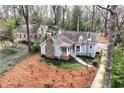 Aerial view of a charming home with a stone chimney, front porch, and mature trees surrounding at 3776 Powers Ferry Nw Rd, Atlanta, GA 30342