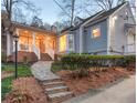 Charming front exterior featuring a stone walkway, inviting porch and manicured landscaping at 3776 Powers Ferry Nw Rd, Atlanta, GA 30342