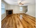Spacious living room with hardwood floors and a fireplace, ready for your personal touch at 412 Pine Log Ct, Canton, GA 30115