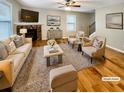 Staged living room with hardwood floors, fireplace, and cozy furniture at 412 Pine Log Ct, Canton, GA 30115