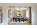 Elegant dining room featuring wainscoting, coffered ceilings, chandelier, and stylish decor for sophisticated dining at 420 Hatcher Ct, Hampton, GA 30228