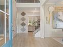 Bright foyer showcases stylish decor, staircase, and an inviting glimpse into the home's living spaces at 420 Hatcher Ct, Hampton, GA 30228