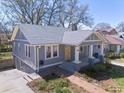 Charming home with a well-maintained lawn, a brick walkway, and a convenient side entrance at 1095 Boulevard Se Dr, Atlanta, GA 30317