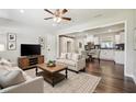 Inviting living room open to kitchen features hardwood floors and neutral decor for relaxation and entertaining at 1554 Pine Ct, Conley, GA 30288