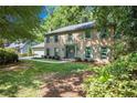 Lovely brick home with green shutters, manicured lawn and mature trees, perfect for Gathering living at 2982 Huntshire Pl, Atlanta, GA 30340