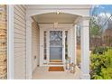Inviting front porch with classic columns, neutral siding, and decorative accents creating a warm welcome at 4019 Somersal Ct, Cumming, GA 30040